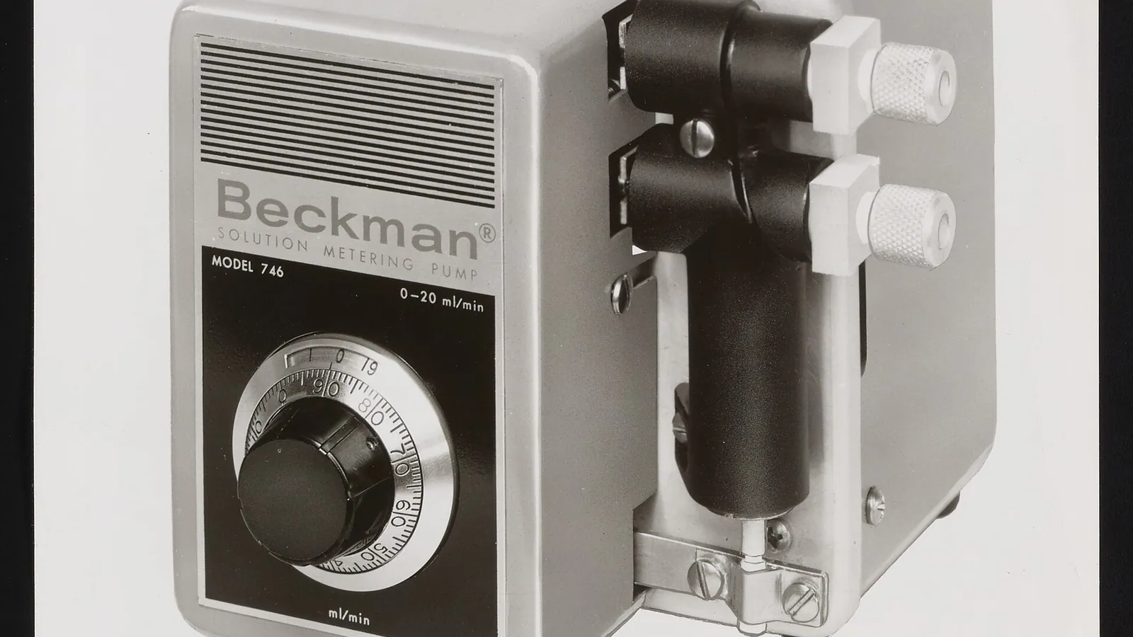 Laboratory-grade metering pump with adjustment dial and pump head
