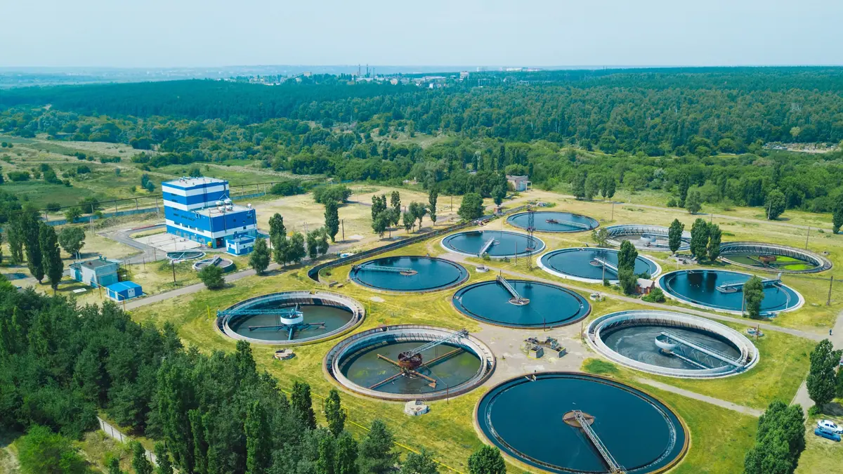 Aerial view of a wastewater treatment plant with circular clarifier basins